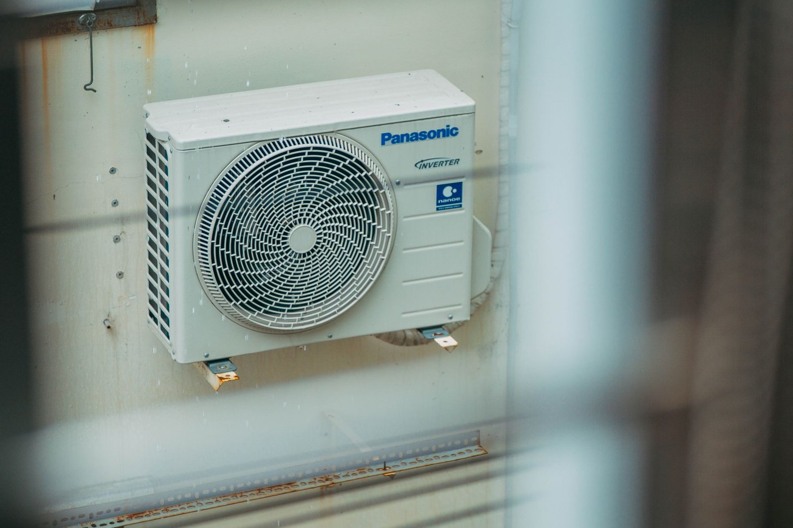 A portable air conditioner window vent kit neatly installed in a sunny residential window.